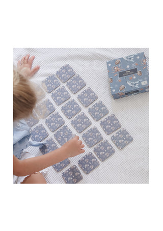Little girl laying out the Modern Monty's Ocean Memory Card Game on the ground