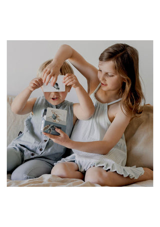 Little Boy & Girl holding up modern monty ocean snap and go fish cards