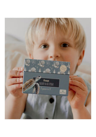 Little boy holding the modern monty ocean snap and go fish