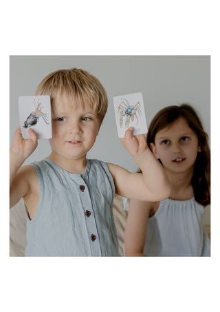 Little boy & girl playing modern monty ocean snap and go fish