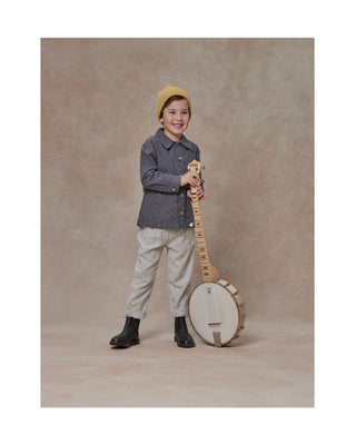 Little Boy wearing Rylee & Cru Boy's Stanley Overshirt in Navy holding a banjo
