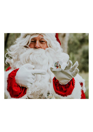 Santa Claus holding up a card from the modern monty christmas memory game
