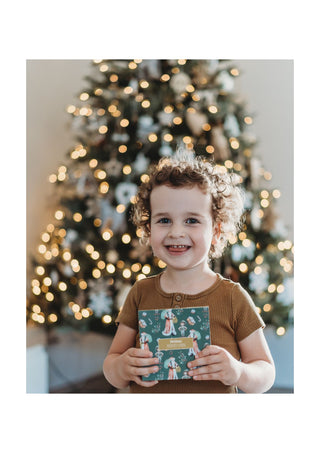 Little boy holding the modern monty christmas memory game