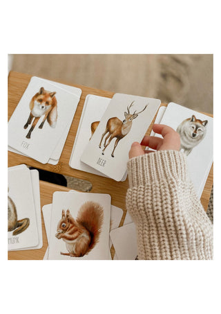 A child playing with the modern monty woodland snap and go card game 