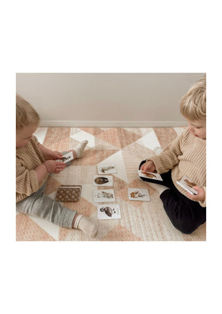 Two kids playing the modern monty woodland snap and go card game